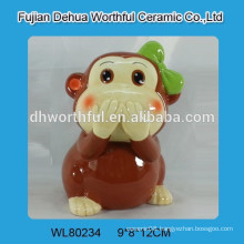 Painting ceramic piggy bank w/ monkey statue